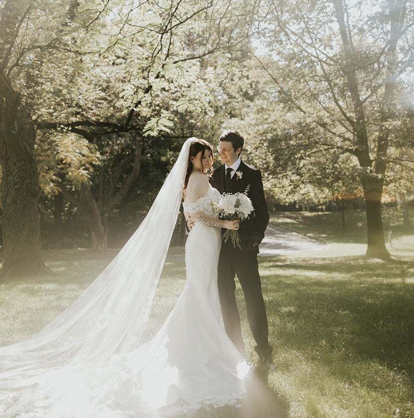 Bride and groom portrait with long veil in soft sunlight Toronto wedding